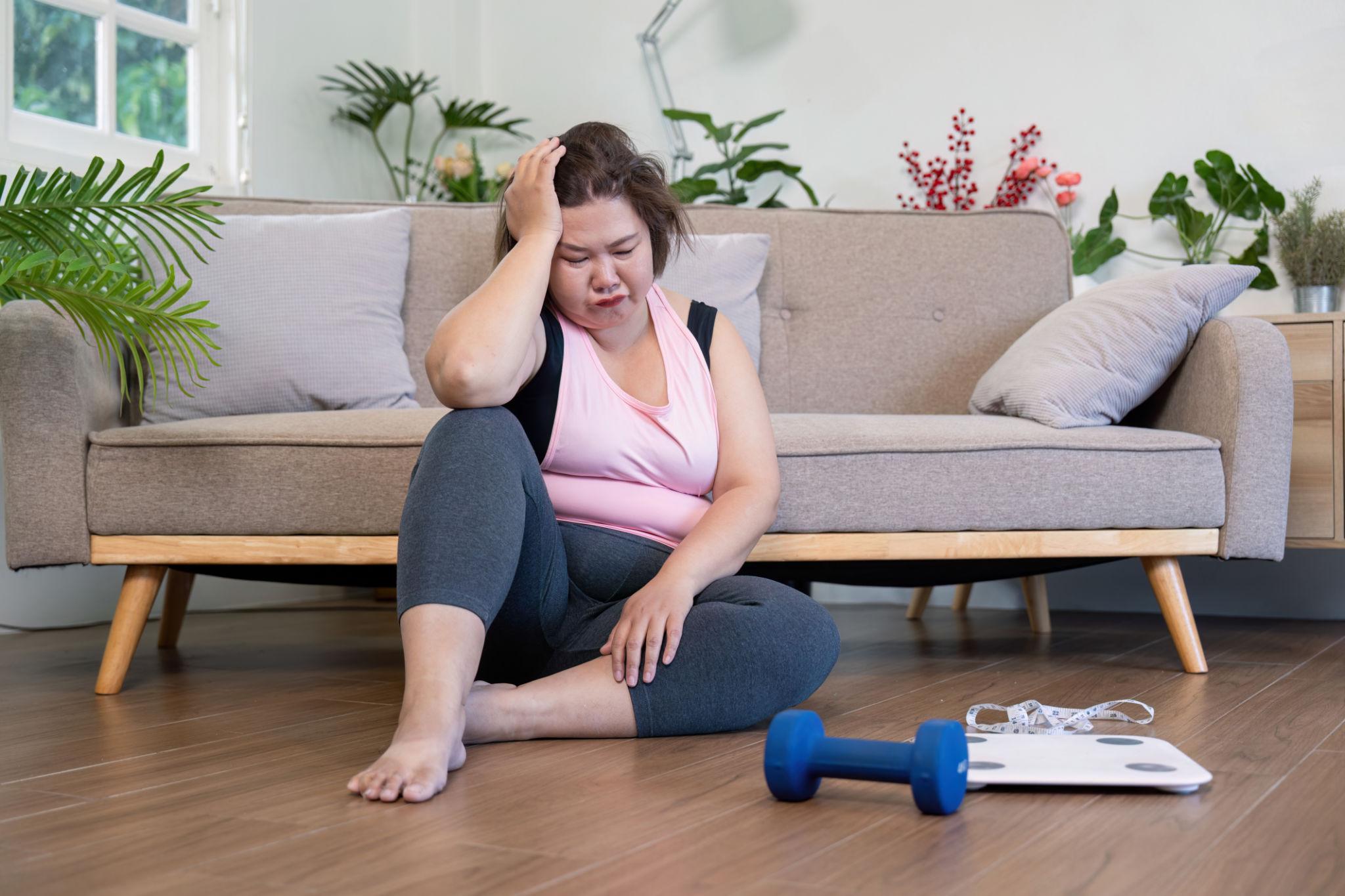 Person frustrated with failed diets and weight loss supplements